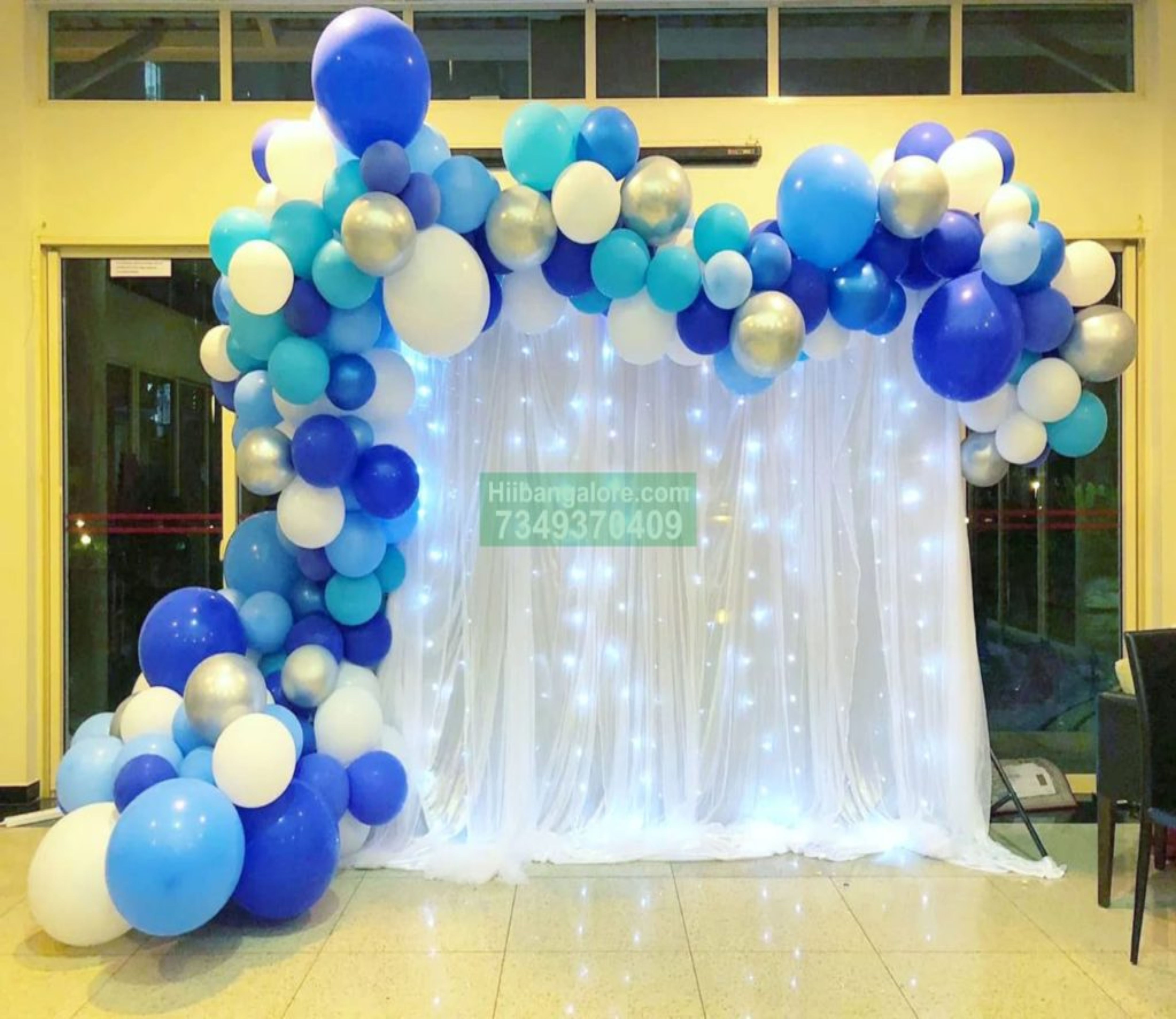 blue and white organic arch balloon decorations at home Bangalore