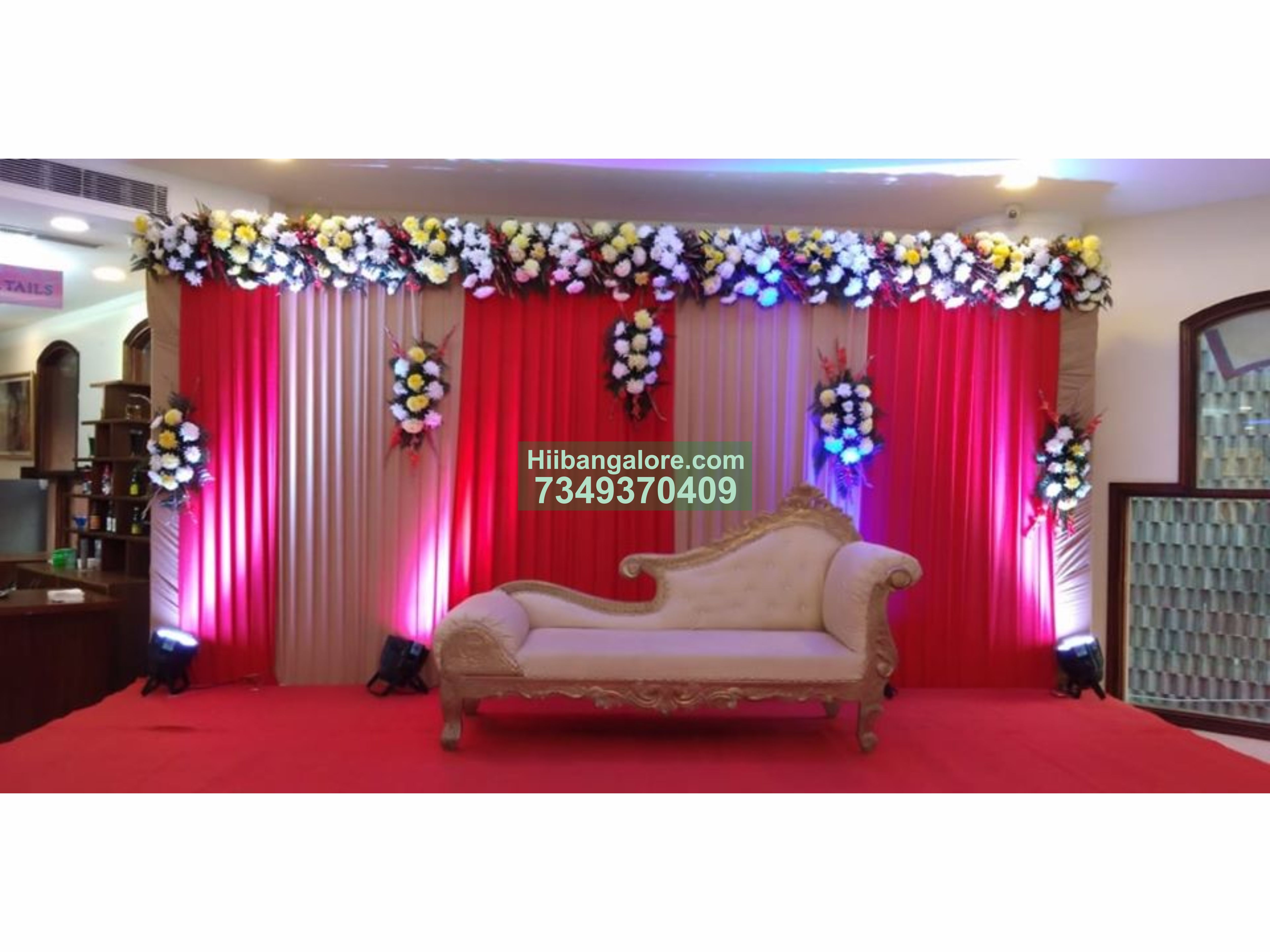 simple engagement decoration with flowers and red backdrop Bangalore