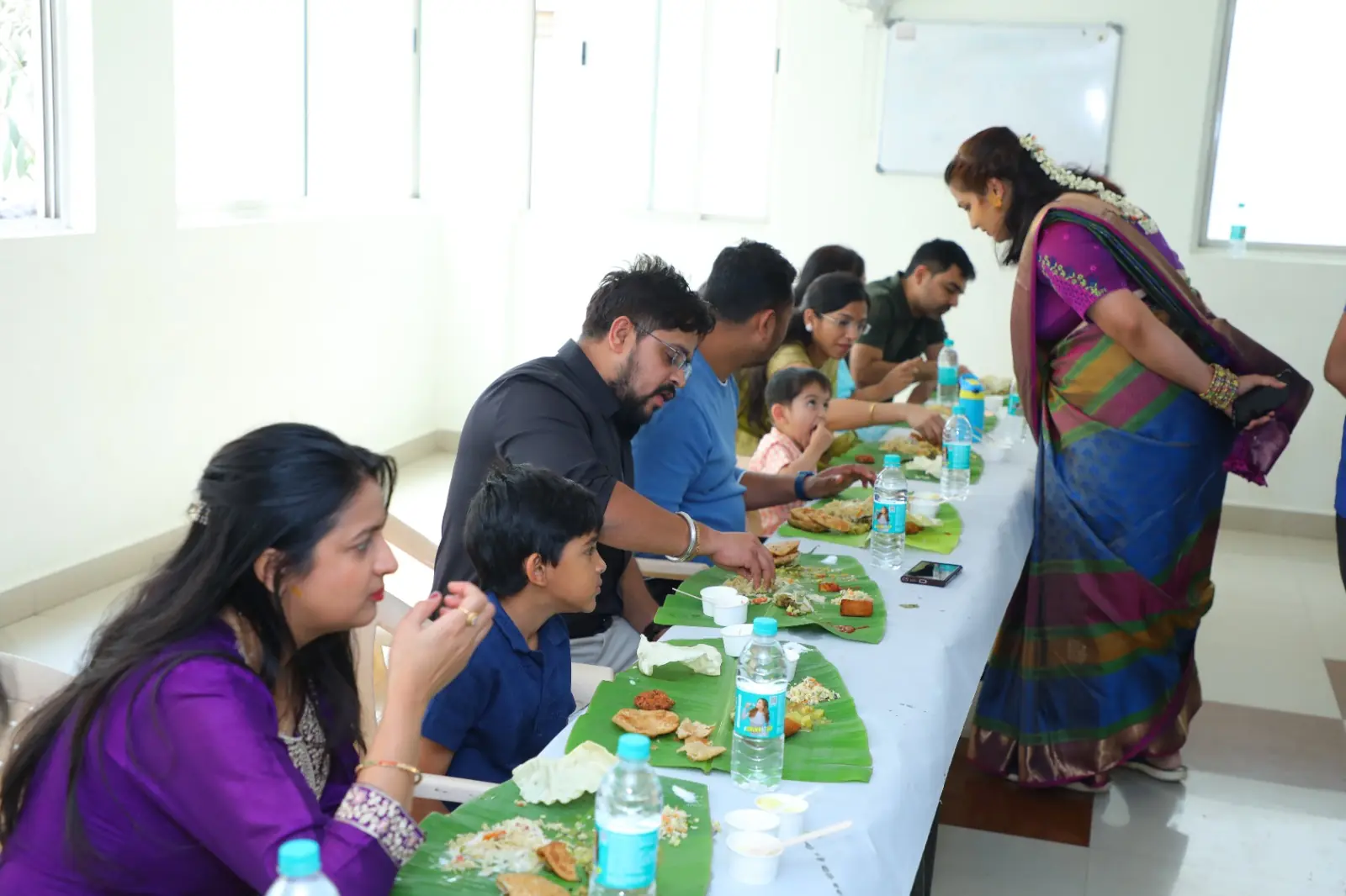 Guests relishing Andhra feast served on banana leaves during an event in Bangalore