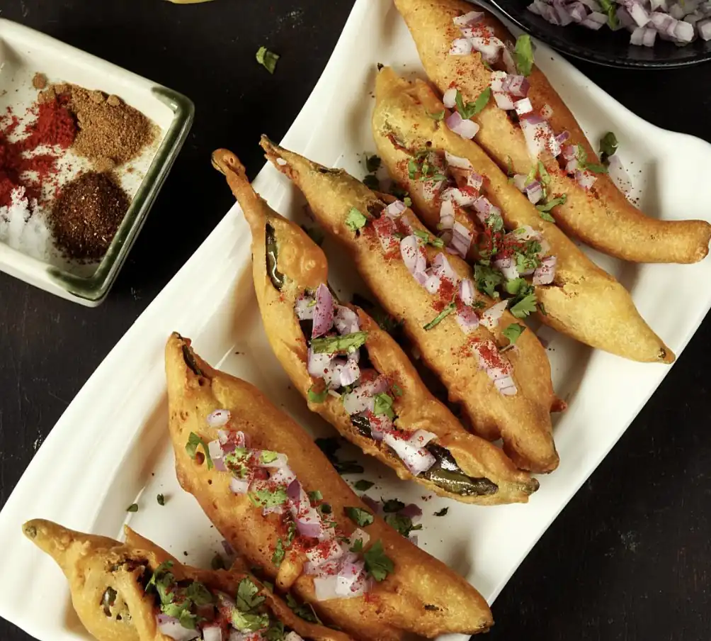 Stuffed chilli bajji topped with onions and spices