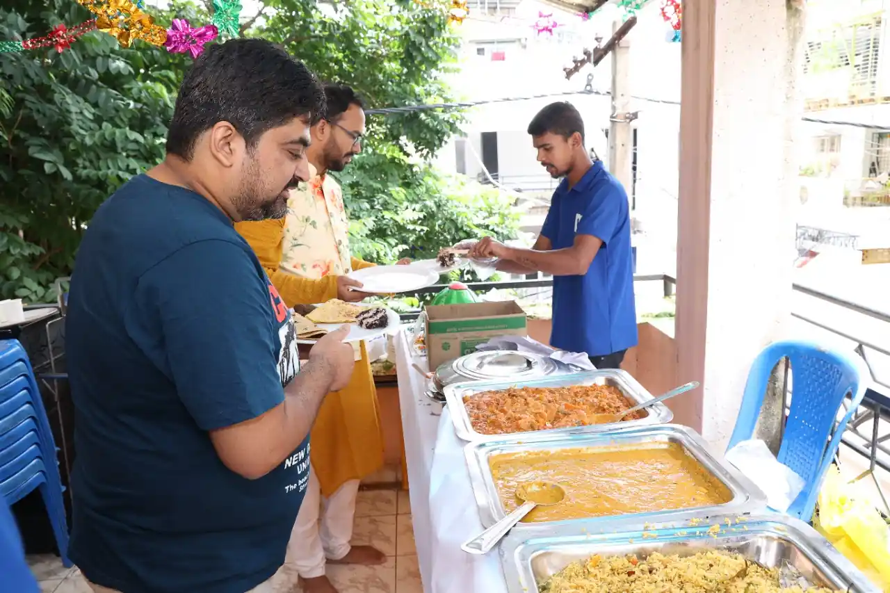 Guests dining at long tables with traditional Andhra banana leaf meal