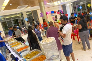Guests being served at a buffet with catering staff managing food service and event support