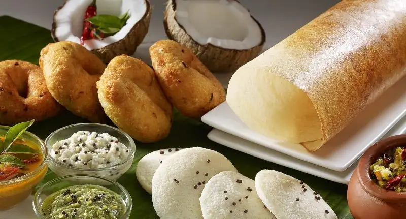 South Indian breakfast catering spread with idli, dosa, vada and chutneys served on banana leaf