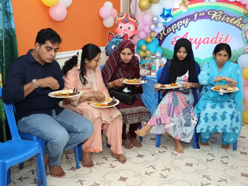Guests enjoying food during a birthday celebration with professional catering service