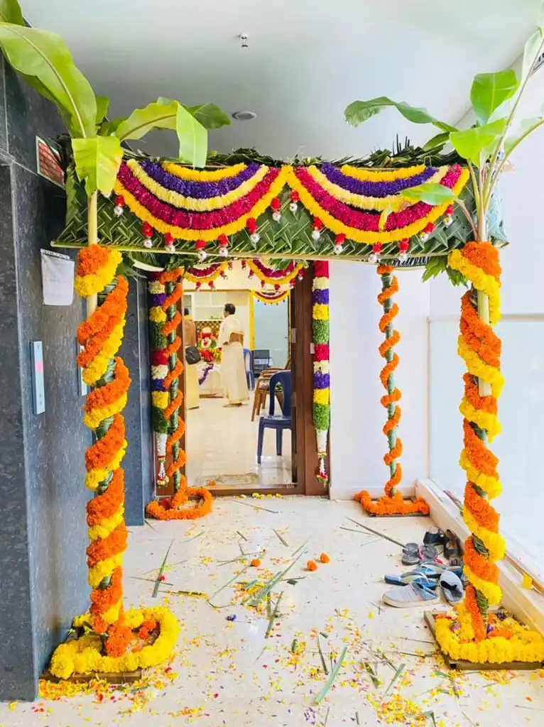 Colorful chappara flower arrangement with marigold garlands for griha pravesh