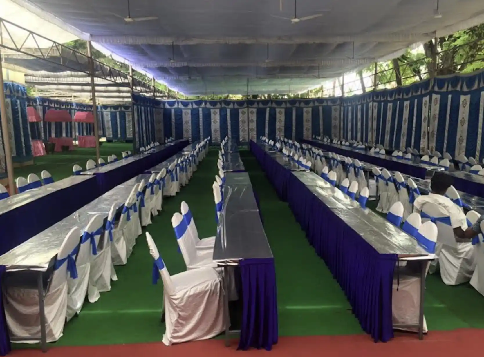 Grand gruhapravesham seating arrangement with long dining tables in Bangalore