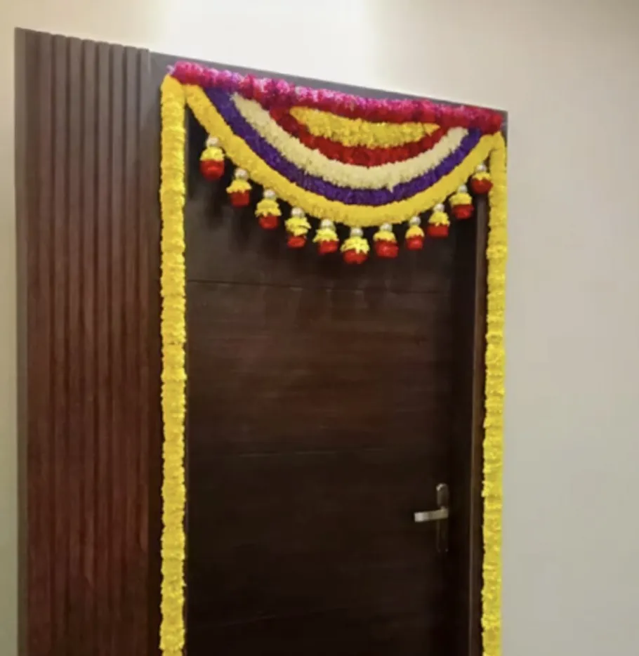 Traditional bedroom door flower decoration for griha pravesh ceremony in Bangalore