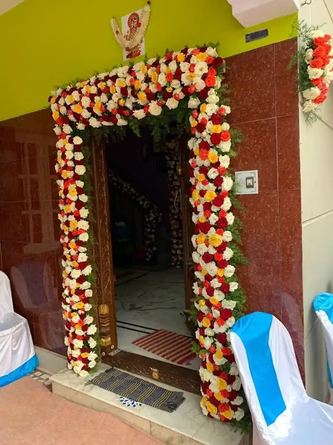 South Indian style griha pravesh main door flower decoration