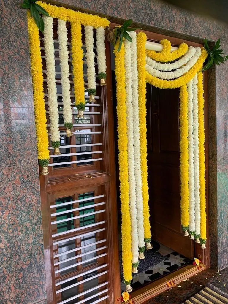 Traditional floral decor for gruhapravesha main door in Bangalore