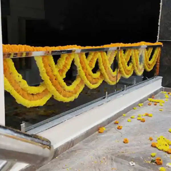 Gruhapravesham balcony decorated with traditional flower garlands