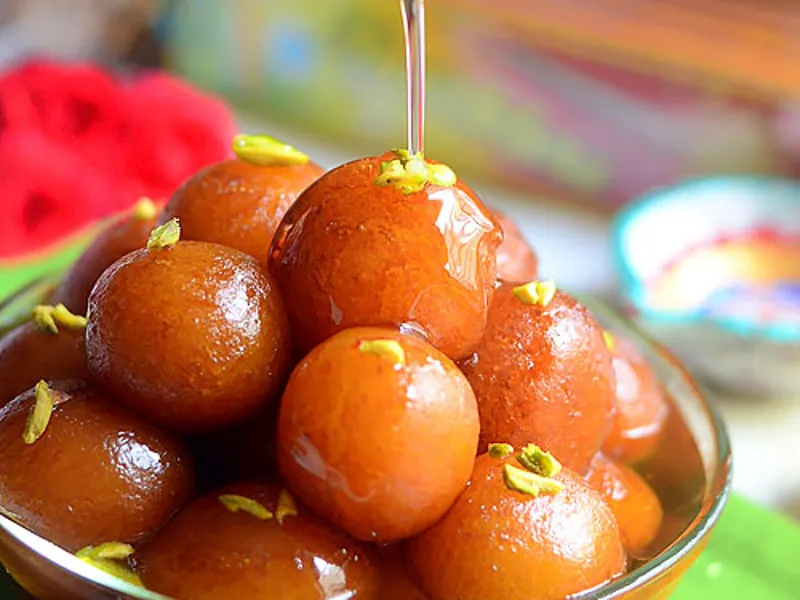 Soft and juicy gulab jamun soaked in sugar syrup served as a traditional Indian dessert