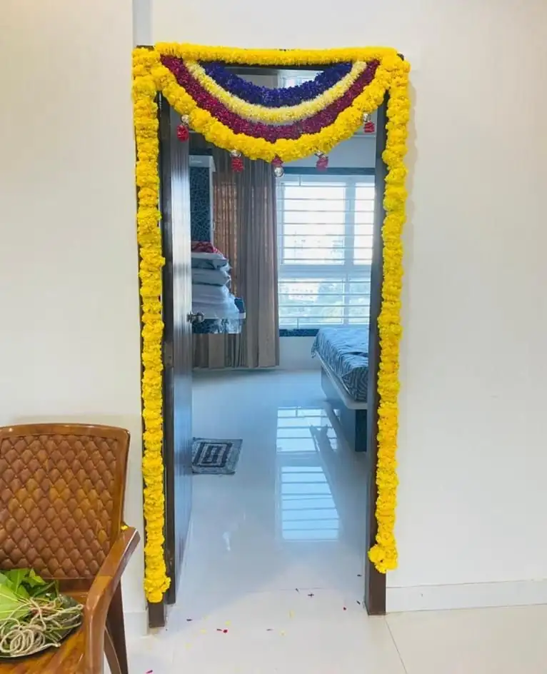 Themed flower decoration for bedroom door during house warming in Bangalore.