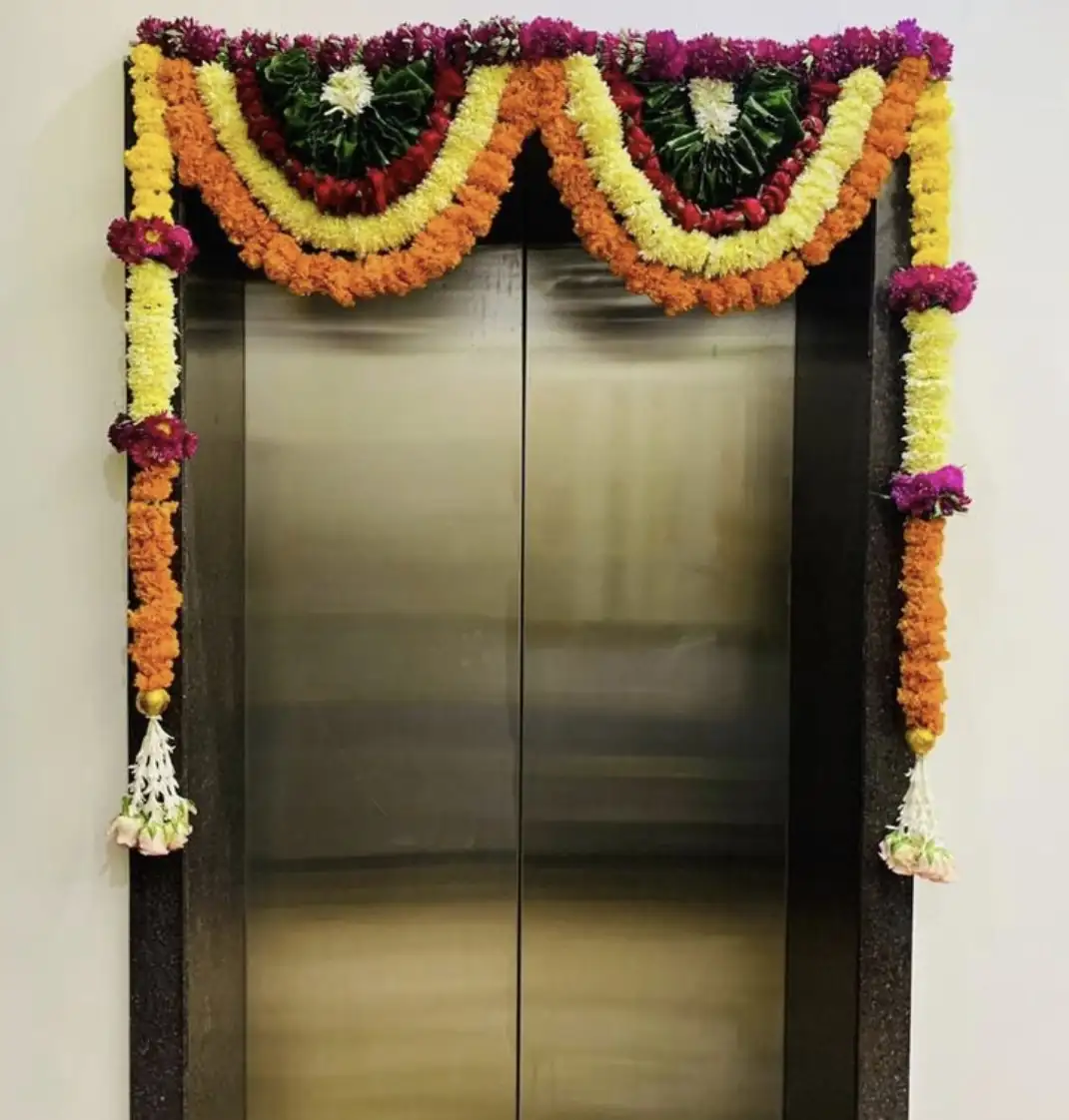 Marigold flower decoration on bedroom door for house warming in Bangalore.