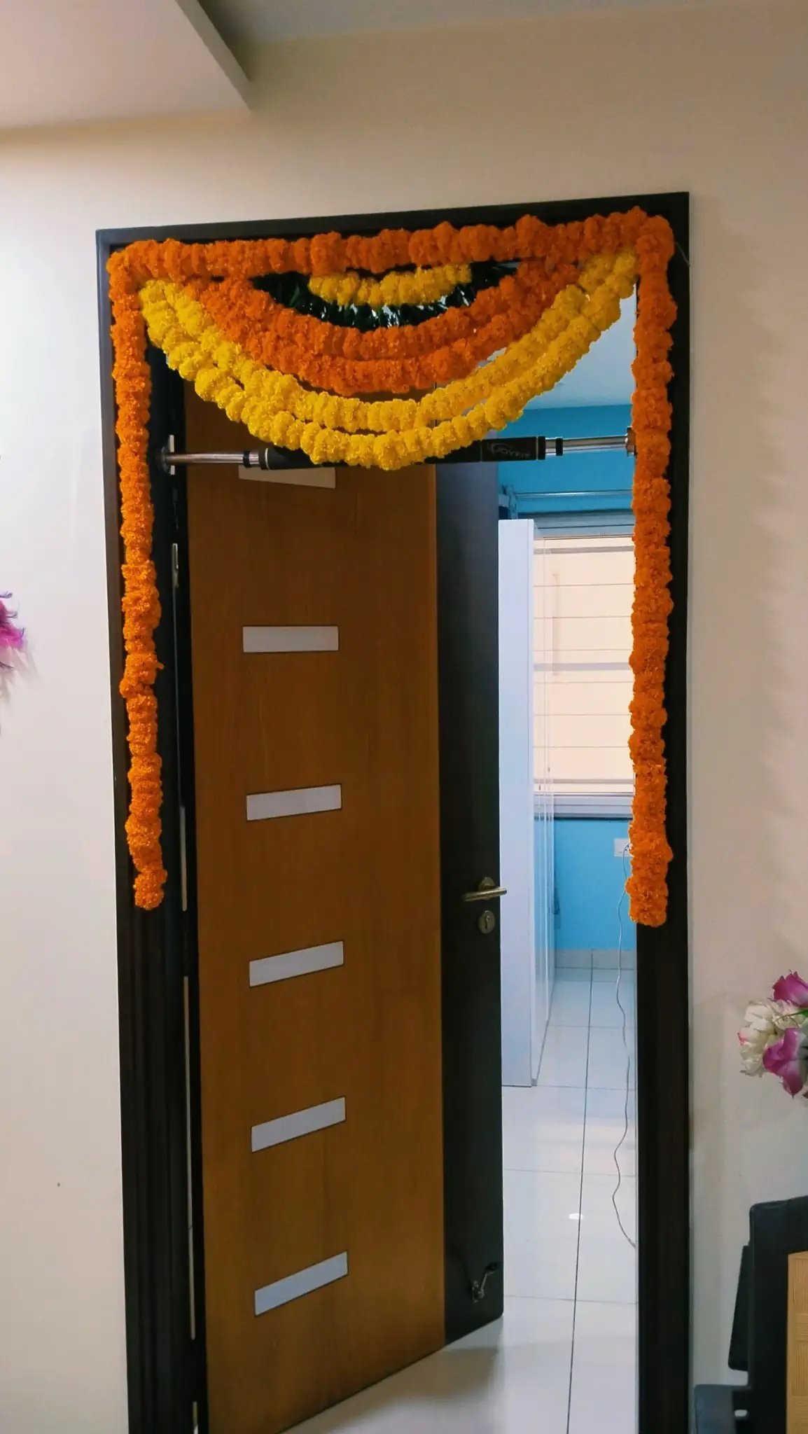 Bedroom door flower decorations for housewarming function in Bangalore.