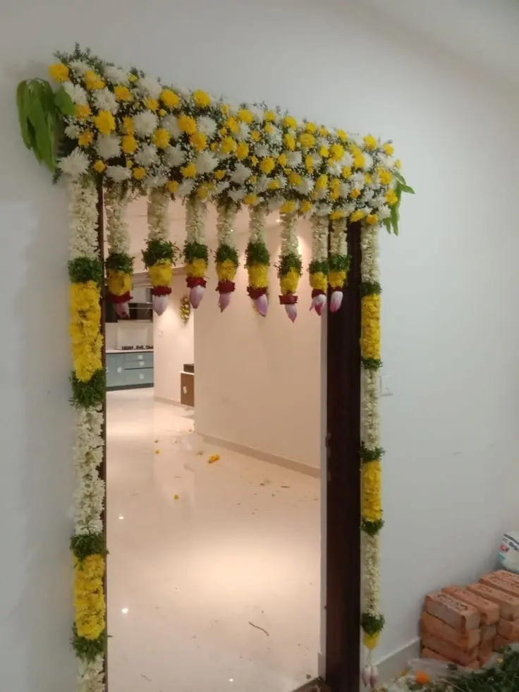 Traditional flower decoration for housewarming entrance door in Bangalore