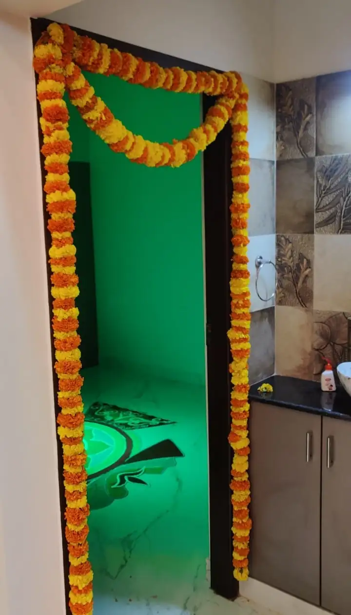 Traditional Indian flower decor for bedroom door during housewarming in Bangalore.