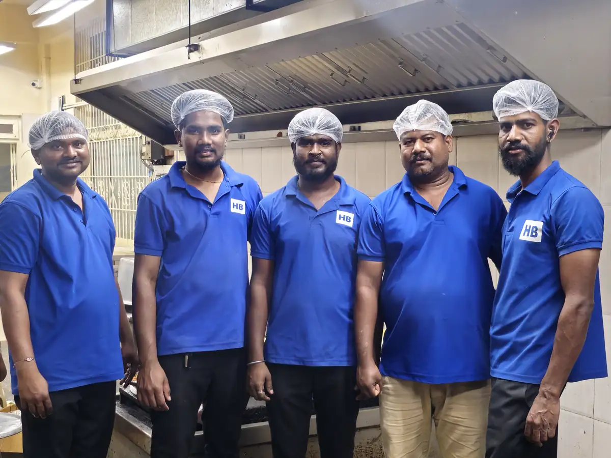 Large event catering team in Bangalore with uniformed professional staff handling food preparation and service