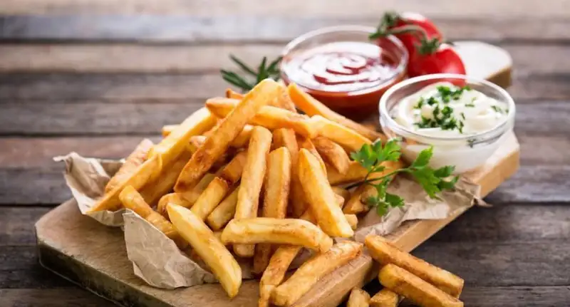 Crispy French fries with sauces served for snacks catering in Bangalore