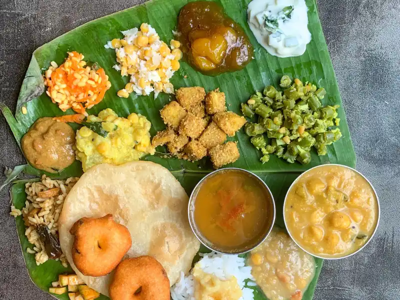 Traditional Tamil Nadu style vegetarian meal served on banana leaf with rice, sambar, poriyal, vadai and curries