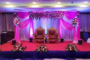 Beautiful engagement stage decoration with floral backdrop and royal seating arranged in Bangalore