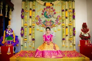 Traditional half saree function decoration with floral backdrop and ceremonial seating in Bangalore