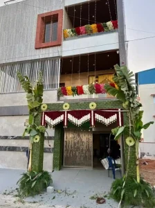 Traditional housewarming ceremony decoration with banana leaves and floral entrance setup in Bangalore