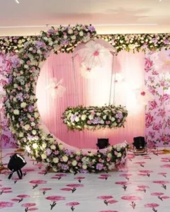 Elegant floral naming ceremony stage decoration with swing setup organised in Bangalore