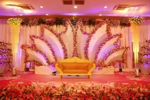 Luxury wedding stage decoration with floral backdrop and royal seating arranged by wedding event organisers in Bangalore