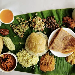 Traditional Karnataka vegetarian catering menu served on banana leaf with dosa, rice, curries and South Indian dishes