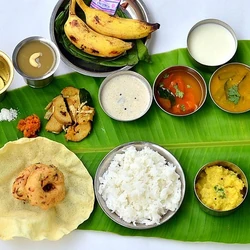 No onion no garlic vegetarian catering meal served on banana leaf with rice, dal and traditional satvik dishes
