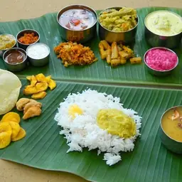 Traditional Tamil Nadu vegetarian catering meal served on banana leaf with rice, sambar, rasam and South Indian dishes