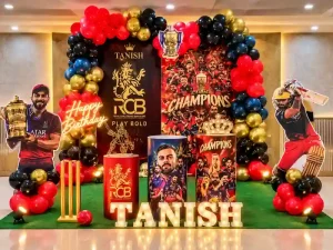 Cricket theme kids birthday decoration with red and black balloon arch, cricket props and birthday backdrop in Bangalore