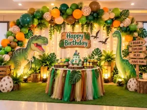 Dinosaur themed birthday party decoration with balloon arch and jungle backdrop in Bangalore