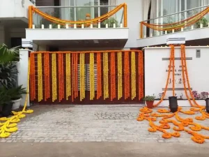 Housewarming outdoor house decoration with marigold flower garlands in Bangalore