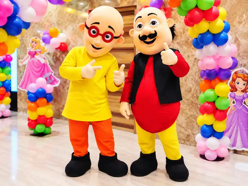 Colorful live mascots entertaining children at a naming ceremony in Bangalore