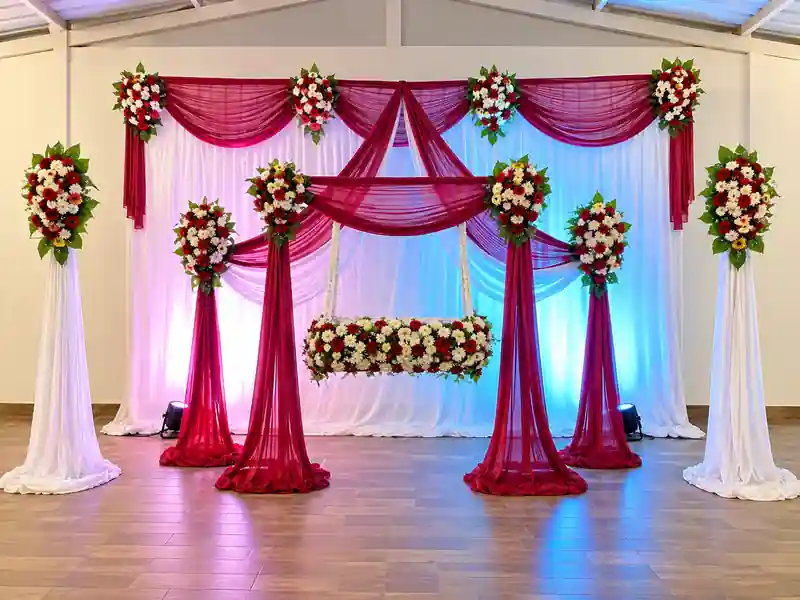 Red and white flower backdrop decoration for naming ceremony in Bangalore