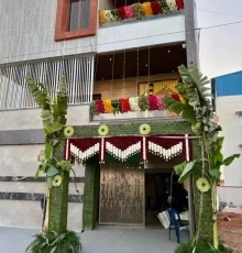 Traditional housewarming ceremony decoration with banana leaves and floral entrance setup in Bangalore