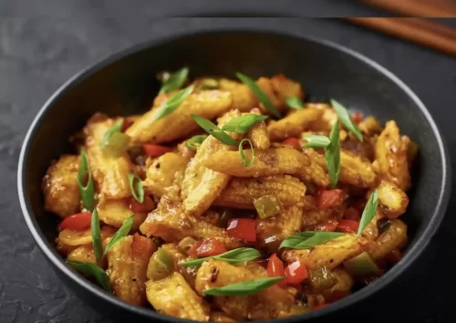 Baby corn manchurian tossed with spices and herbs