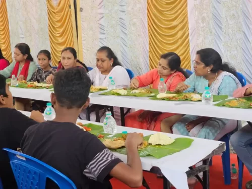 People dining on Andhra-style banana leaf meal at a family function in Bangalore