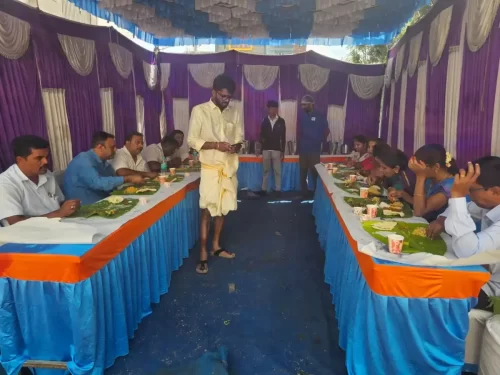 Long serving table with banana leaves and festive food setup