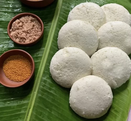 Soft steamed Andhra style idly served on banana leaf by catering service in Bangalore