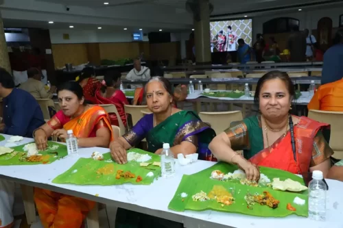 Women dining on banana leaves during a traditional Andhra style meal service