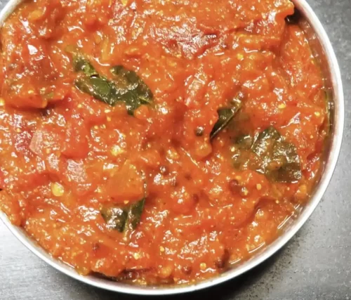 Andhra style tomato curry with traditional spices for catering services in Bangalore