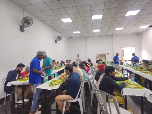 Guests seated and enjoying Andhra style wedding feast on banana leaves