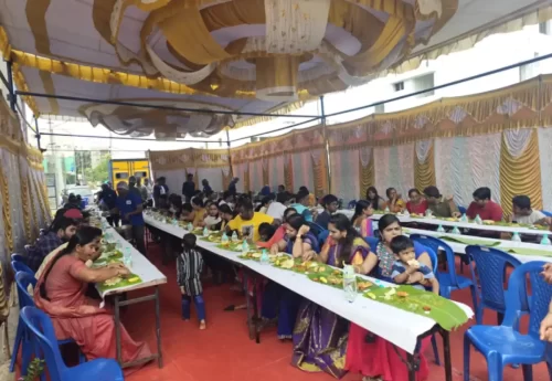 Guests enjoying authentic Andhra vegetarian meal served on banana leaves at a function