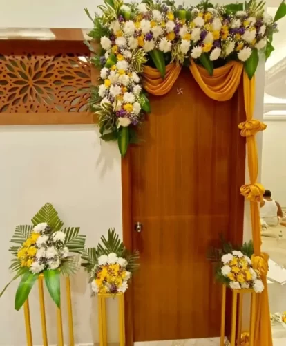 Stylish apartment entrance flower decoration for housewarming ceremony in Bangalore
