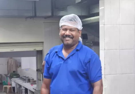 Expert Andhra style chef working in a professional catering kitchen