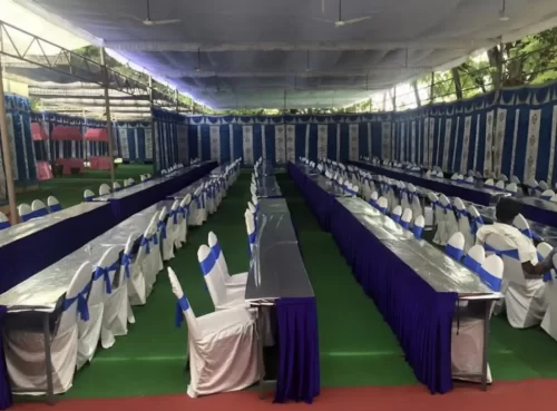 Grand gruhapravesham seating arrangement with long dining tables in Bangalore