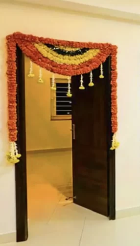 Marigold flower decor for bedroom door during griha pravesh in Bangalore