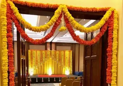 Fresh flower bedroom door decoration for griha pravesh ceremony in Bangalore.